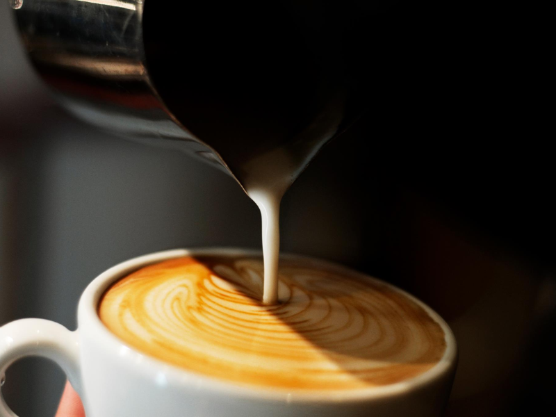 Milk being poured into a latte