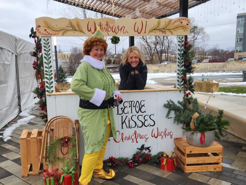 Buddy the Elf and a woman posing in a photo booth