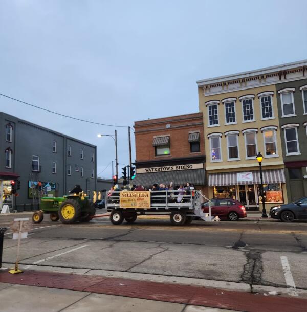 Tractor pulling a trailer of people in a downtown