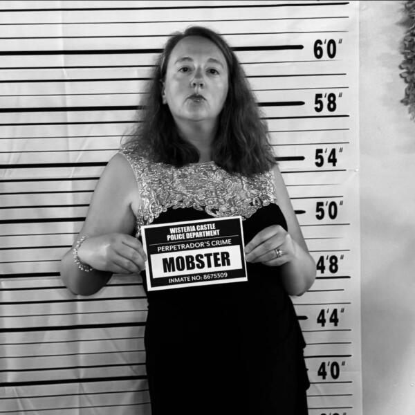 Person taking a fake mug shot at a photo booth