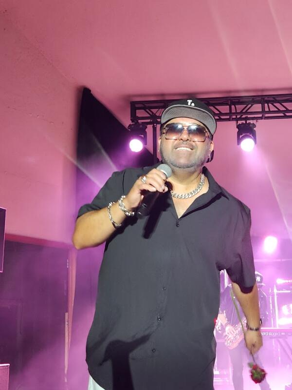 Color Me Badd with a rose in their hand