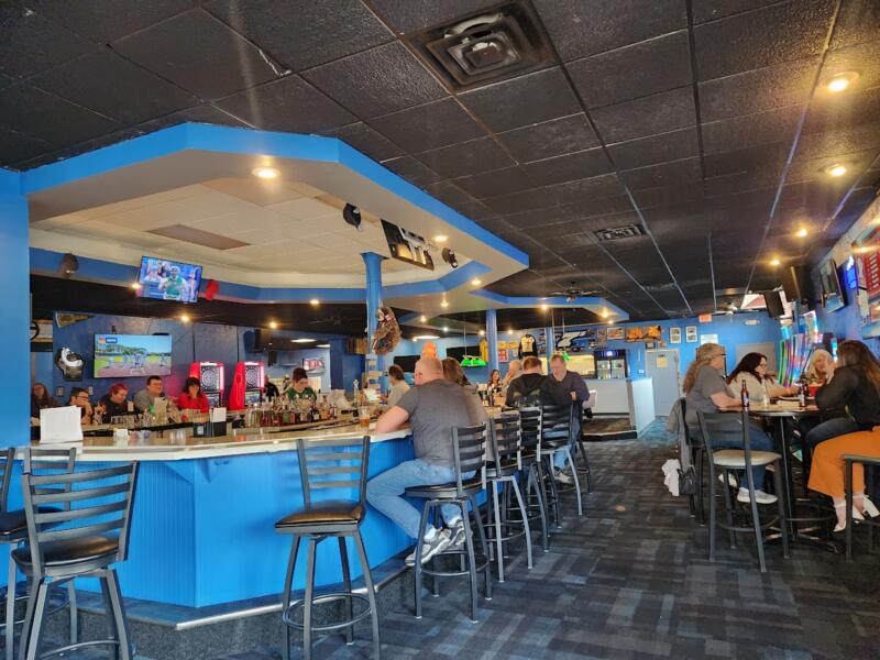 People sitting at the bar of Wolfgram Sports Bar & Grill in Watertown Wi