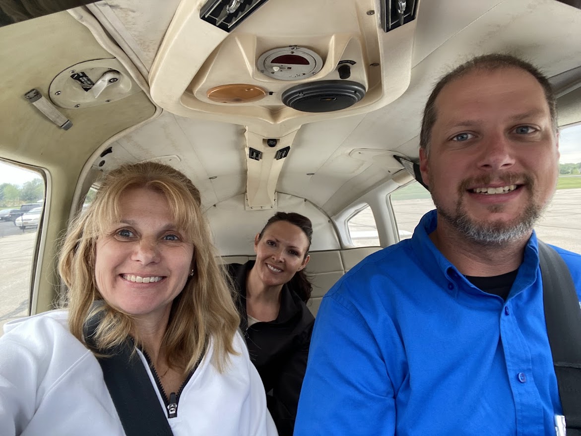 three people in a plane