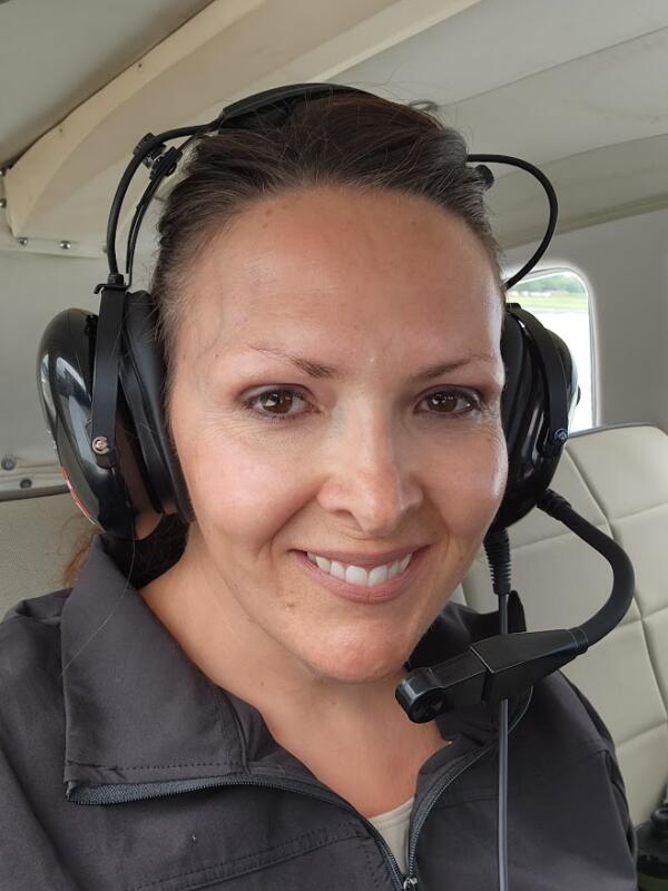 Woman wearing a headset in a plane.