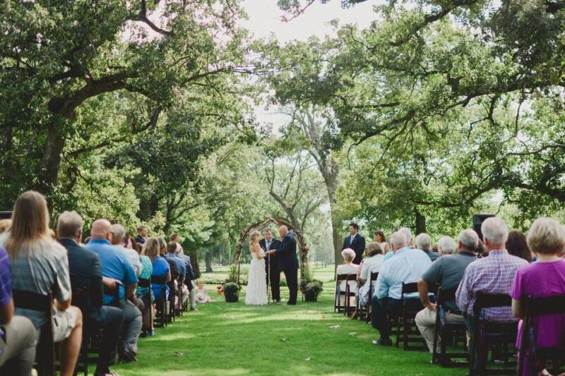 Bride, groom, and guests at an outdoor wedding at the Watertown Country Club