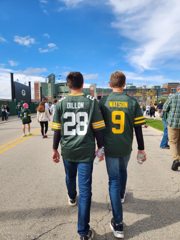 Two teens walking towards Lambeau Field in Green Bay with Packers Jerseys on