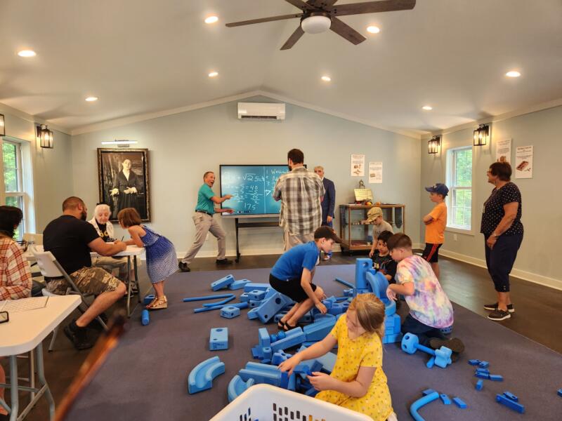 Adults and kids playing in the interactive classroom at America's First Kindergarten in watertown, wi