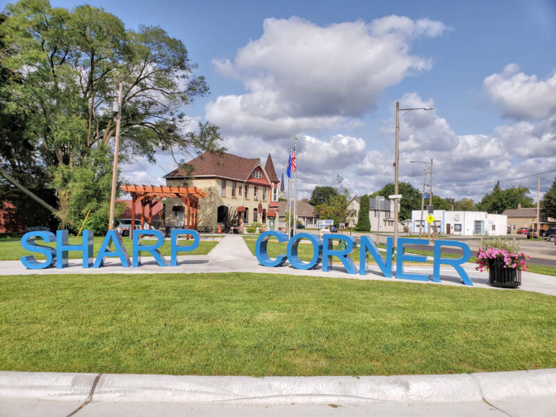 Sharp Corner spelled out in signage with a pergola at a park