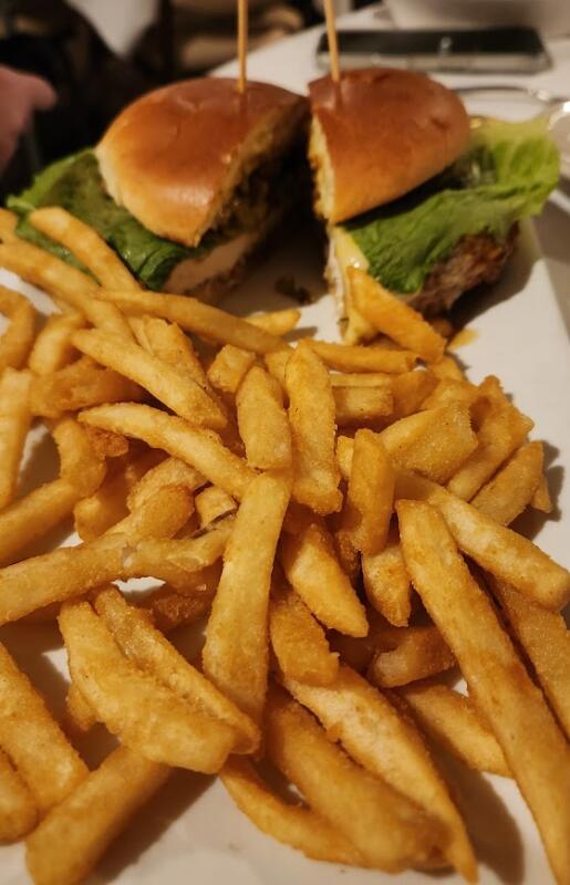 french fries and a chicken sandwich in the foreground
