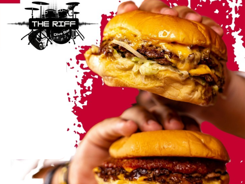 Hands holding smashburgers on a menu