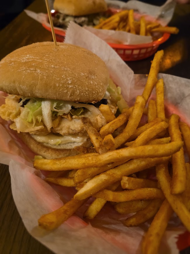 Broasted chicken sandwich and french fries in a basket from Goose & Gander Pub and Grill in Watertown Wi