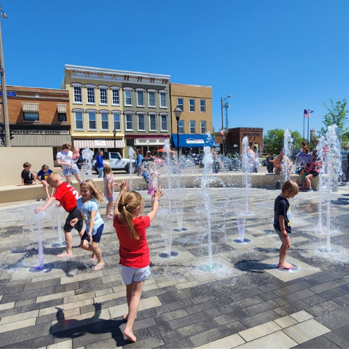BFTS web homepage Kids playing in water feature at Bentzin Family Town Square in Watertown Wi