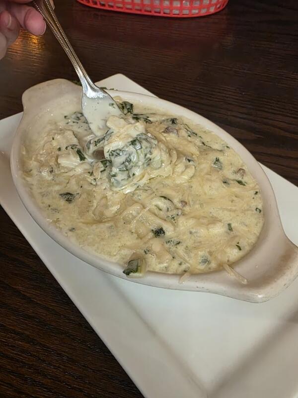 noodles in a white sauce with a fork in the bowl.