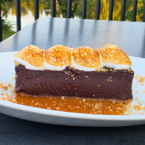 500×500 Smores Bar Dessert S'mores Bar on a plate with a river view in the background.